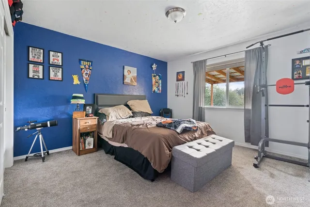 a bedroom with a bed and a table