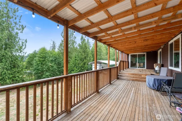 a view of porch with furniture and wooden floor