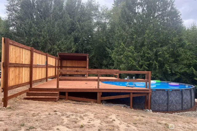a view of roof deck with wooden floor and seating space