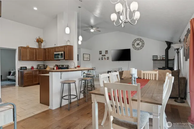 a view of kitchen with cabinets stainless steel appliances furniture and a window