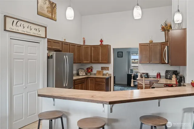 a kitchen with stainless steel appliances granite countertop a refrigerator and a stove top oven