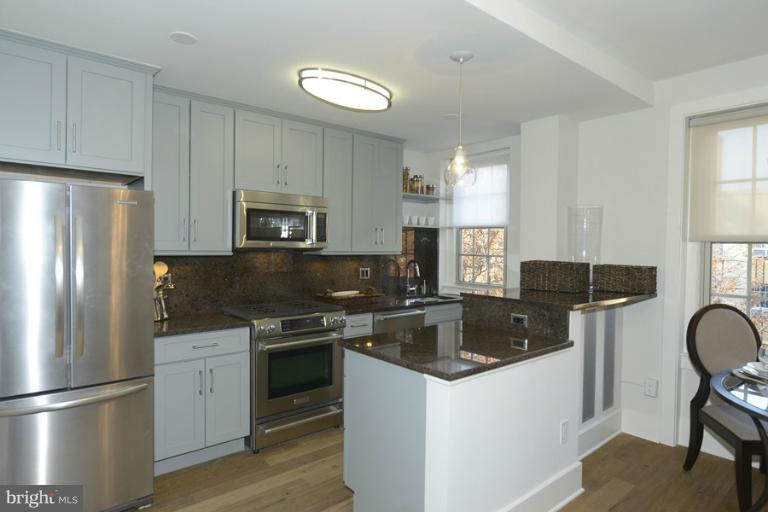 a kitchen with a refrigerator stove and microwave