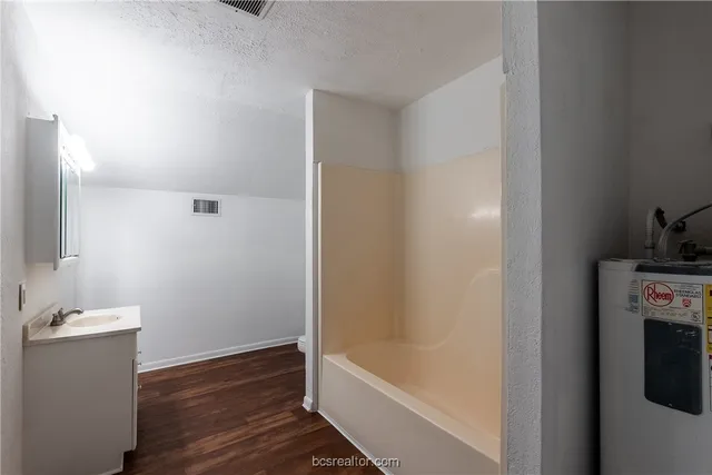 a bathroom with a bathtub and a sink