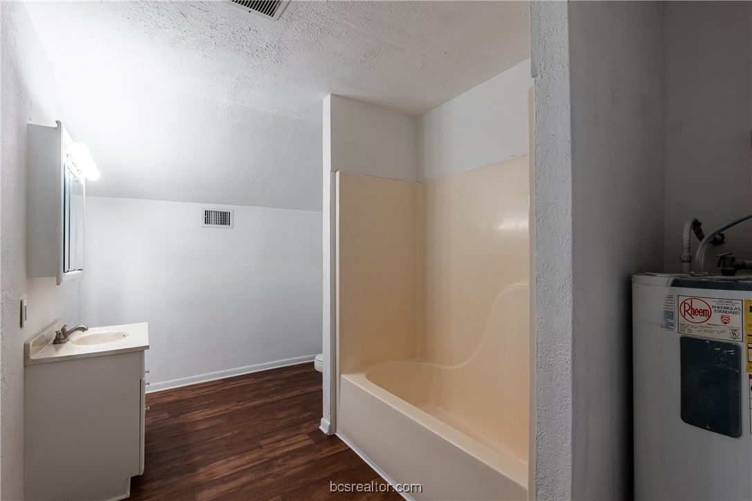 9812 Runaway Road College Station, TX 77845 - Photo 11 of 18 a bathroom with a bathtub and a sink