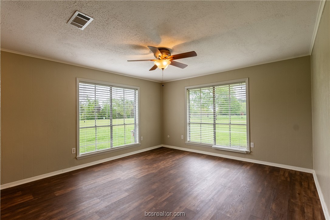 9812 Runaway Road College Station, TX 77845 - Photo 15 of 18 a view of an empty room with wooden floor and a window