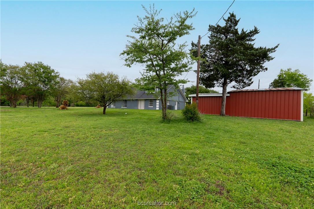 9812 Runaway Road College Station, TX 77845 - Photo 17 of 18 a view of backyard with huge green area and large trees