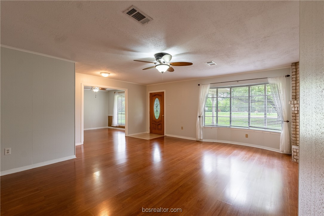9812 Runaway Road College Station, TX 77845 - Photo 2 of 18 a view of an empty room with wooden floor and a window