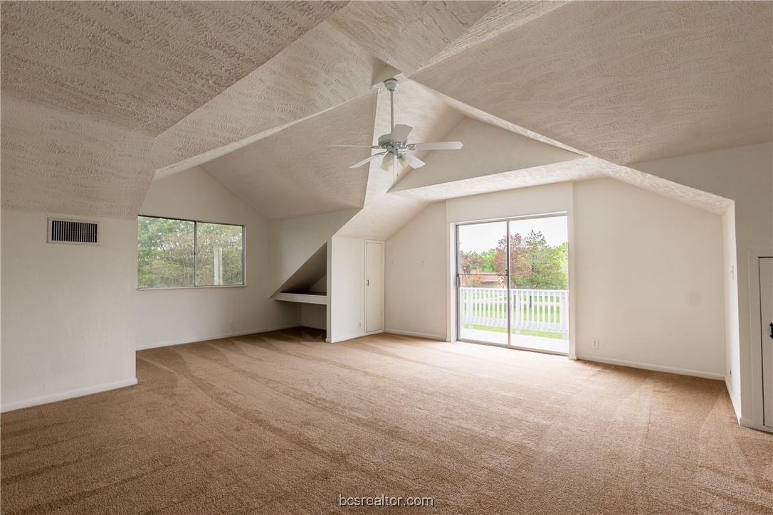 9812 Runaway Road College Station, TX 77845 - Photo 9 of 18 an empty room with windows and chandelier fan