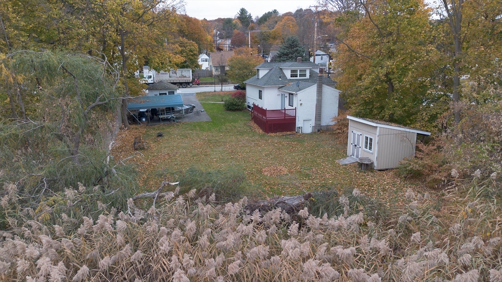 82 Holden Street Worcester, MA 01605 - Photo 6 of 19 a backyard of a house with fire pit and outdoor seating