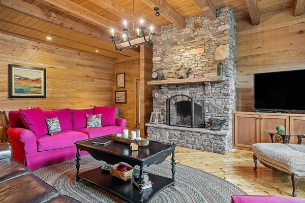 a living room with furniture fireplace and flat screen tv