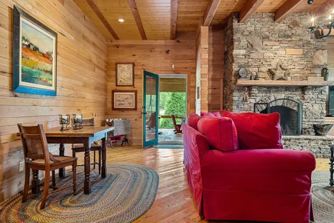 a living room with furniture and a floor to ceiling window
