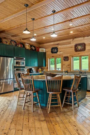 a bedroom with a bed and large windows