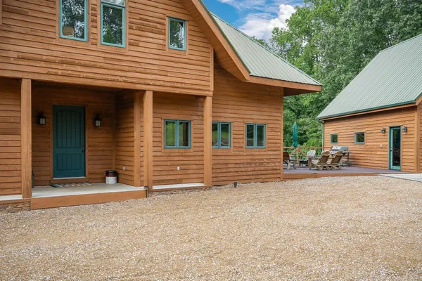 a view of a balcony with chairs and wooden floor