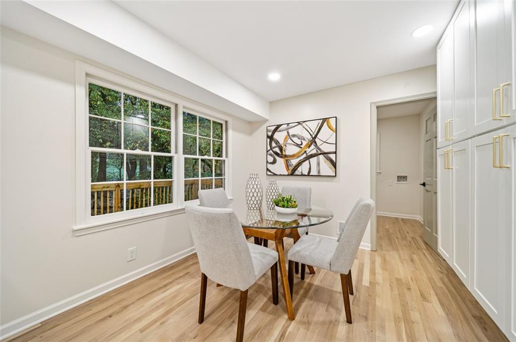 2089 Carthage Road Tucker, GA 30084 - Photo 13 of 38 a view of a dining room with furniture a potted plant and wooden floor