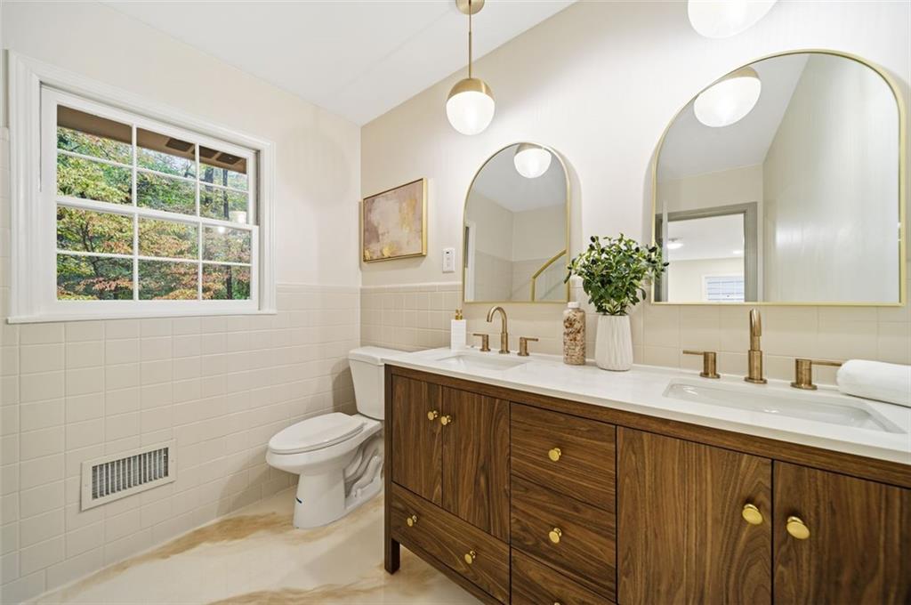 2089 Carthage Road Tucker, GA 30084 - Photo 19 of 38 a bathroom with a double vanity sink a toilet and a mirror