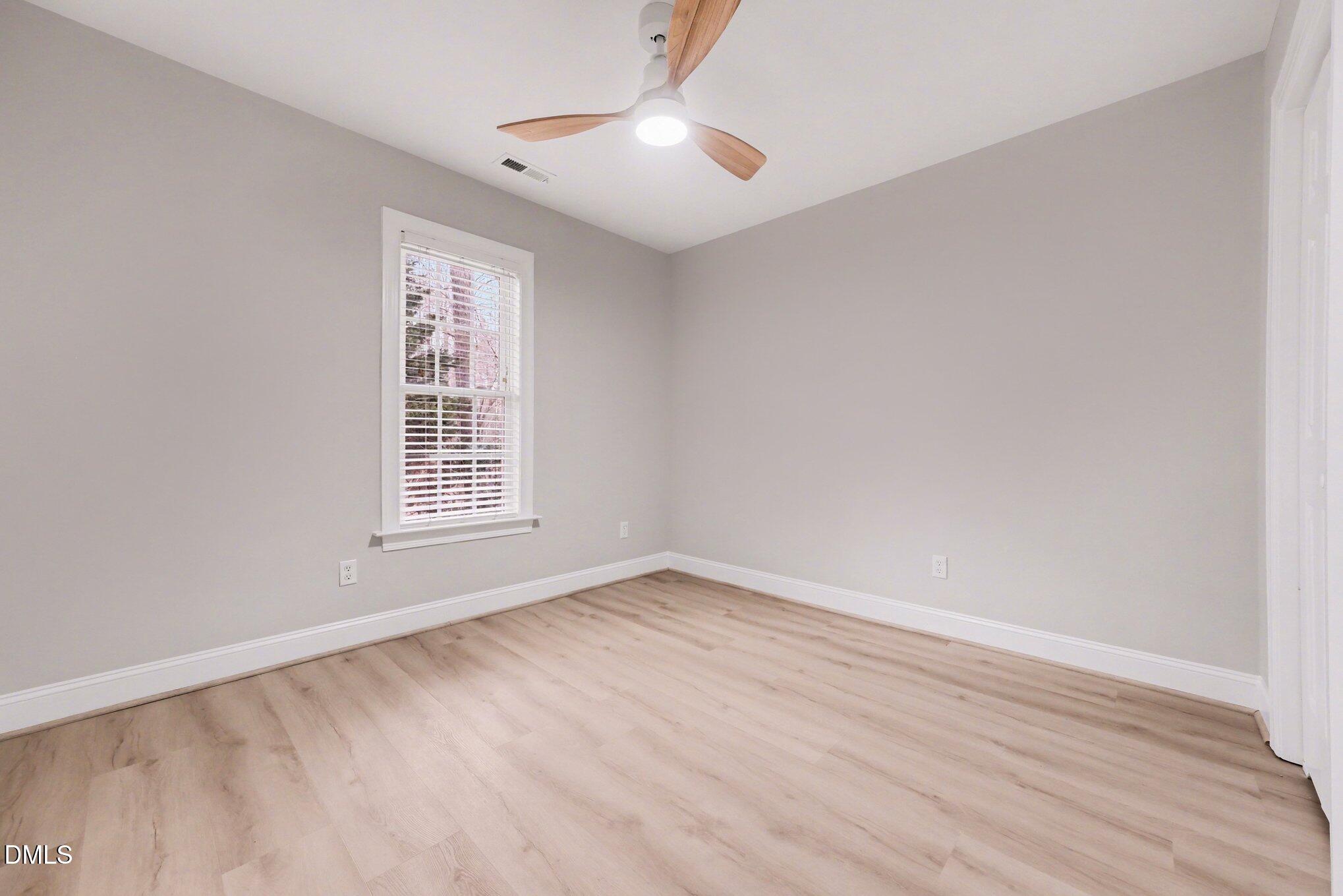 4613 Cherrybark Lane Raleigh, NC 27616 - Photo 18 of 27 wooden floor in an empty room with a window