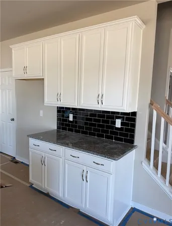 a view of a room with wooden floor and windows