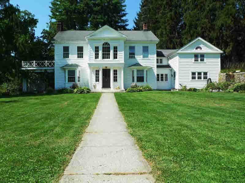 a front view of a house with a yard