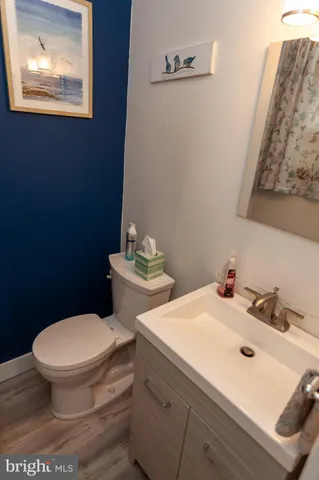 a white toilet sitting next to a bathroom sink
