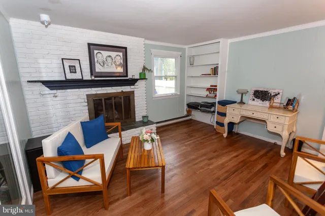 a living room with furniture fireplace and a window
