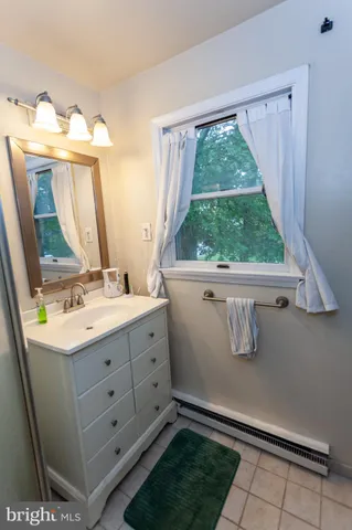 a room with a sink and a mirror