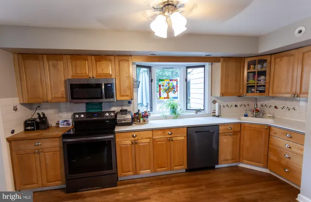 a kitchen with a sink stove and microwave