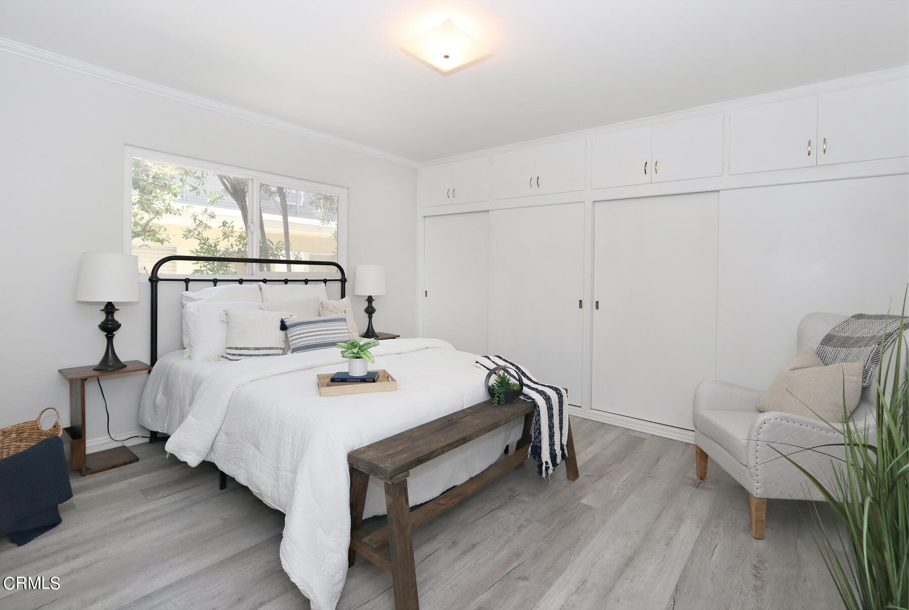 1023 East Appleton Street, Unit 5 Long Beach, CA 90802 - Photo 10 of 15 a bedroom with a bed and wooden floor