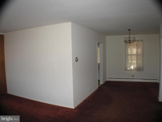 4131 Raleigh Road Pikesville, MD 21208 - Photo 11 of 11 an empty room with wooden floor and windows