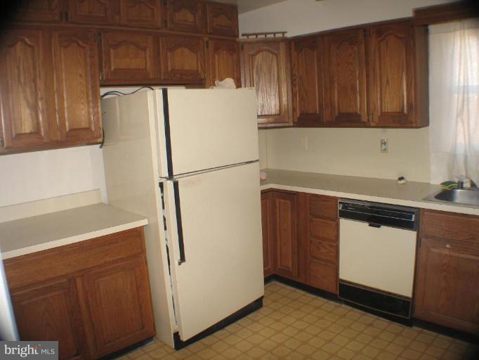 4131 Raleigh Road Pikesville, MD 21208 - Photo 5 of 11 a kitchen with stainless steel appliances a refrigerator and a sink