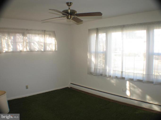 4131 Raleigh Road Pikesville, MD 21208 - Photo 6 of 11 a view of an empty room and window