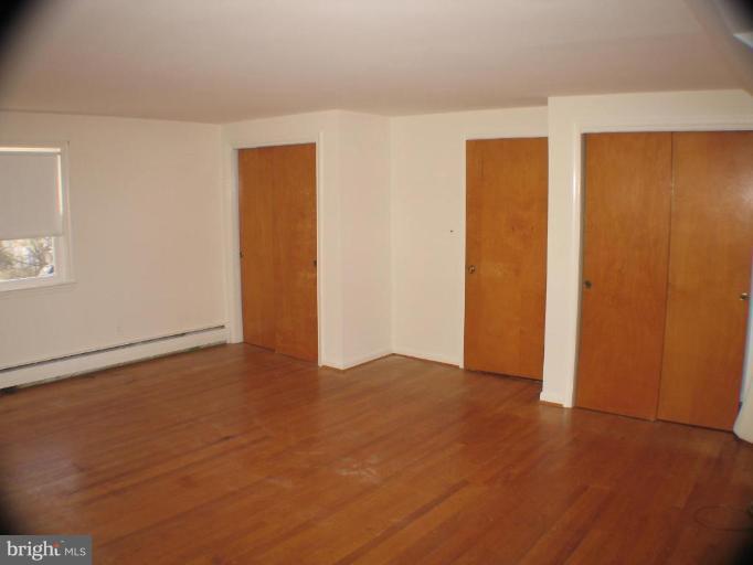 4131 Raleigh Road Pikesville, MD 21208 - Photo 8 of 11 a view of an empty room with a closet