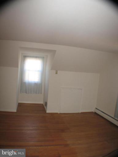 4131 Raleigh Road Pikesville, MD 21208 - Photo 9 of 11 a view of an empty room and wooden floor