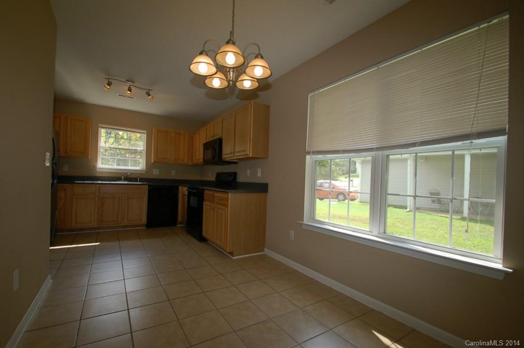 918 Valley Ridge Road Charlotte, NC 28214 - Photo 4 of 12 a kitchen with stainless steel appliances granite countertop a sink and a stove