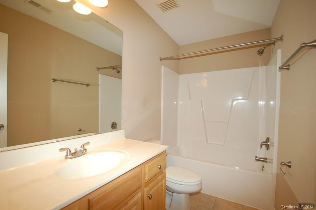 918 Valley Ridge Road Charlotte, NC 28214 - Photo 9 of 12 a bathroom with a sink and a mirror