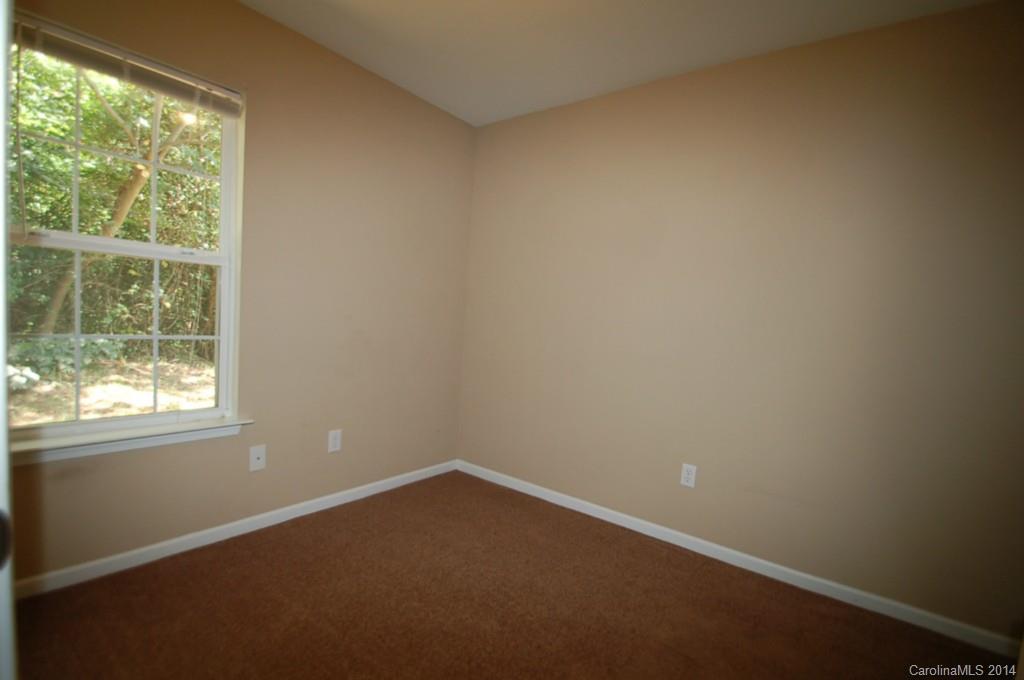 918 Valley Ridge Road Charlotte, NC 28214 - Photo 10 of 12 an empty room with a window