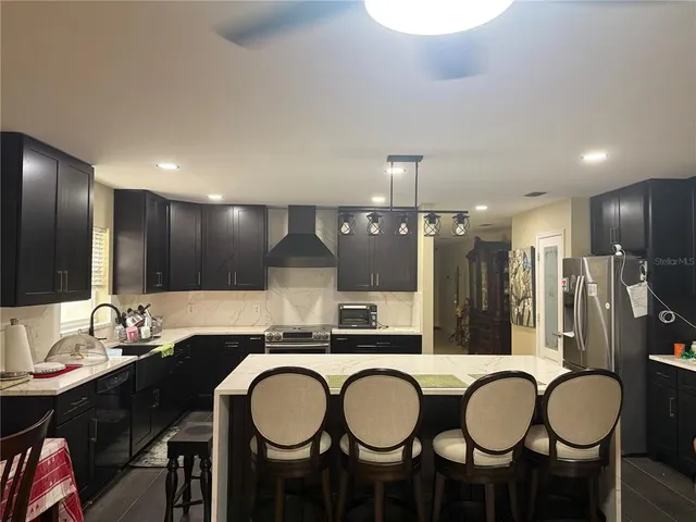 a kitchen with a table chairs stove and kitchen view