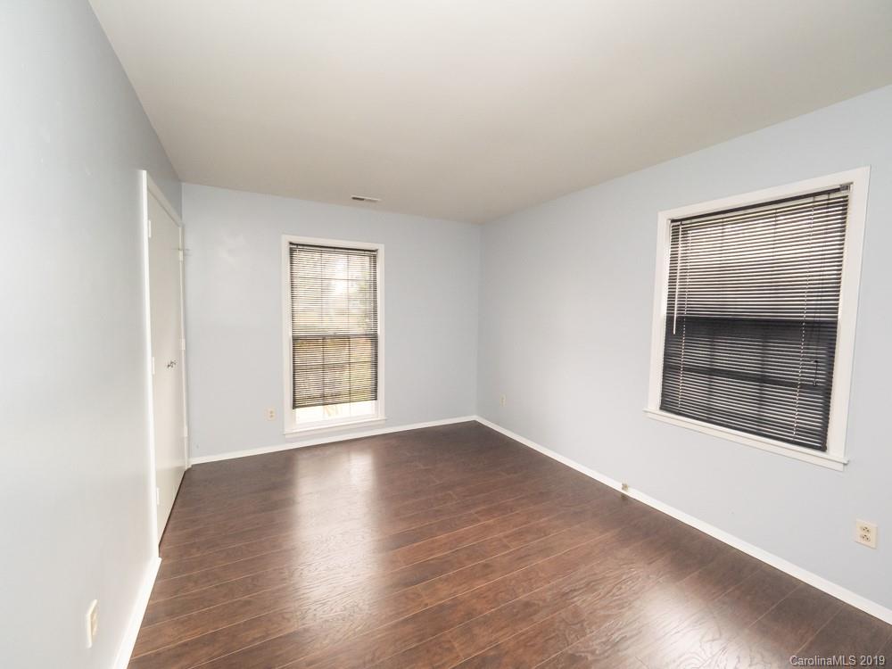 1300 Rock Point Road Charlotte, NC 28270 - Photo 11 of 13 a view of an empty room with wooden floor and a window