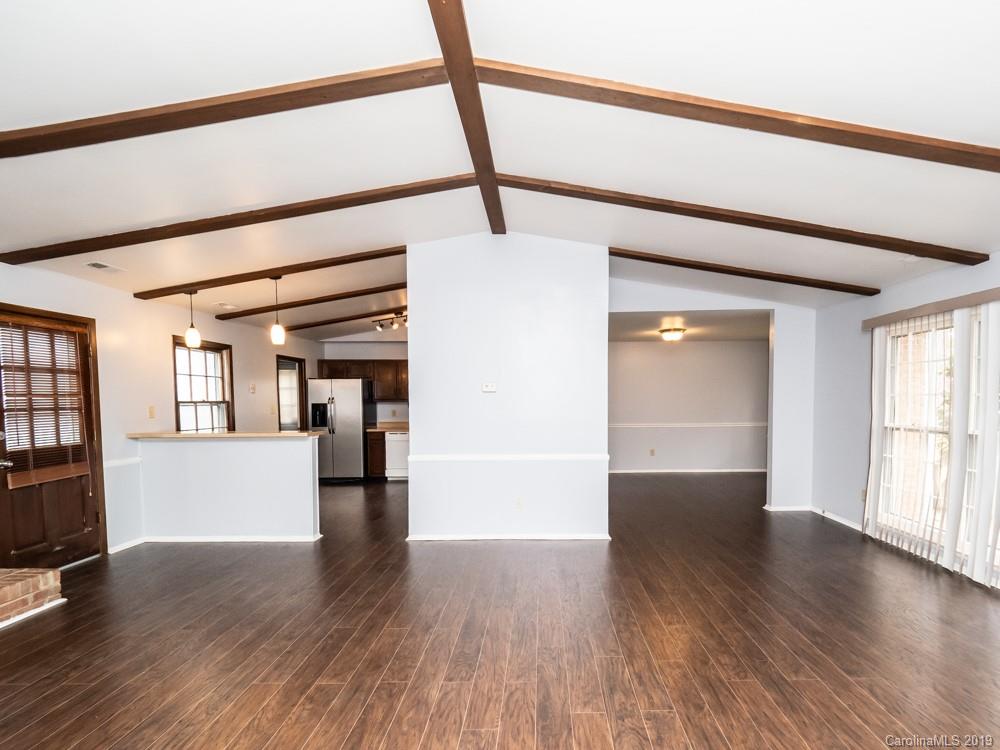 1300 Rock Point Road Charlotte, NC 28270 - Photo 3 of 13 a view of empty room with wooden floor and kitchen window
