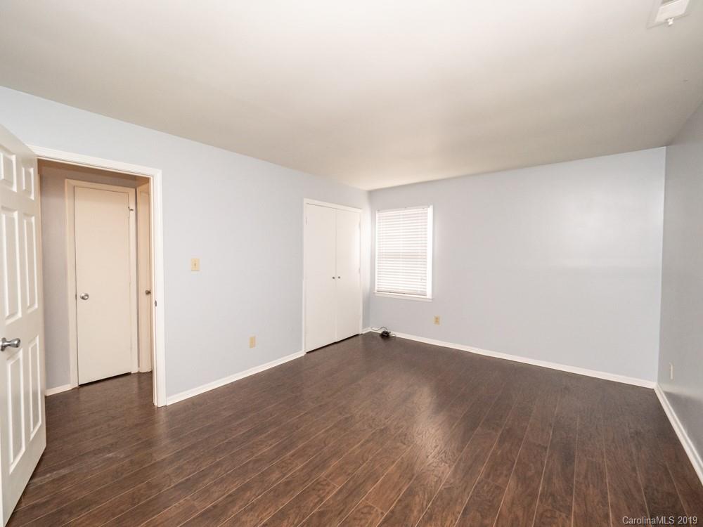 1300 Rock Point Road Charlotte, NC 28270 - Photo 10 of 13 a view of an empty room with wooden floor and a window