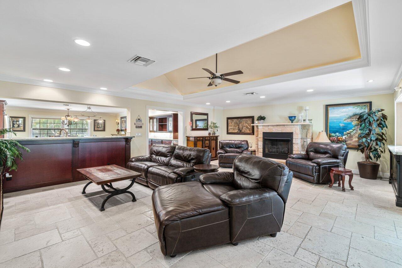 5861 Roebuck Road Jupiter, FL 33458 - Photo 13 of 74 a living room with furniture and a fireplace
