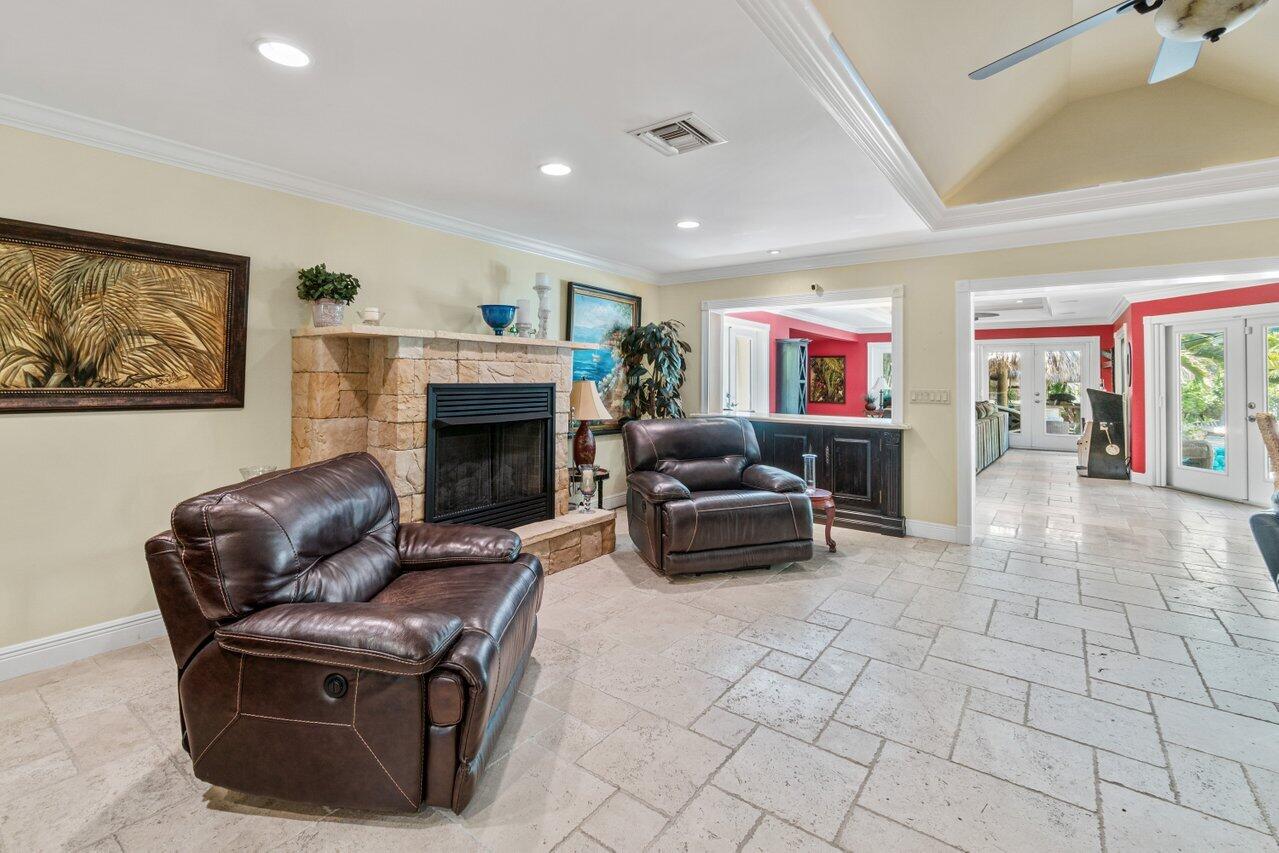5861 Roebuck Road Jupiter, FL 33458 - Photo 16 of 74 a living room with furniture and a fireplace