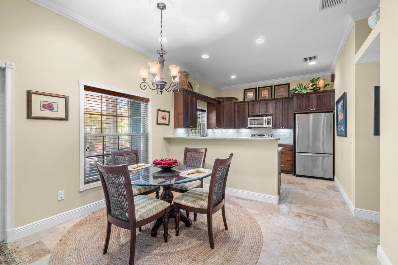 5861 Roebuck Road Jupiter, FL 33458 - Photo 30 of 74 a dining room with furniture a window and kitchen view