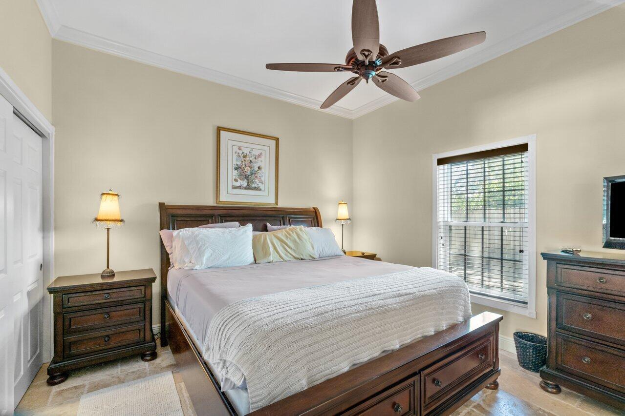5861 Roebuck Road Jupiter, FL 33458 - Photo 36 of 74 a bedroom with a bed and a dresser