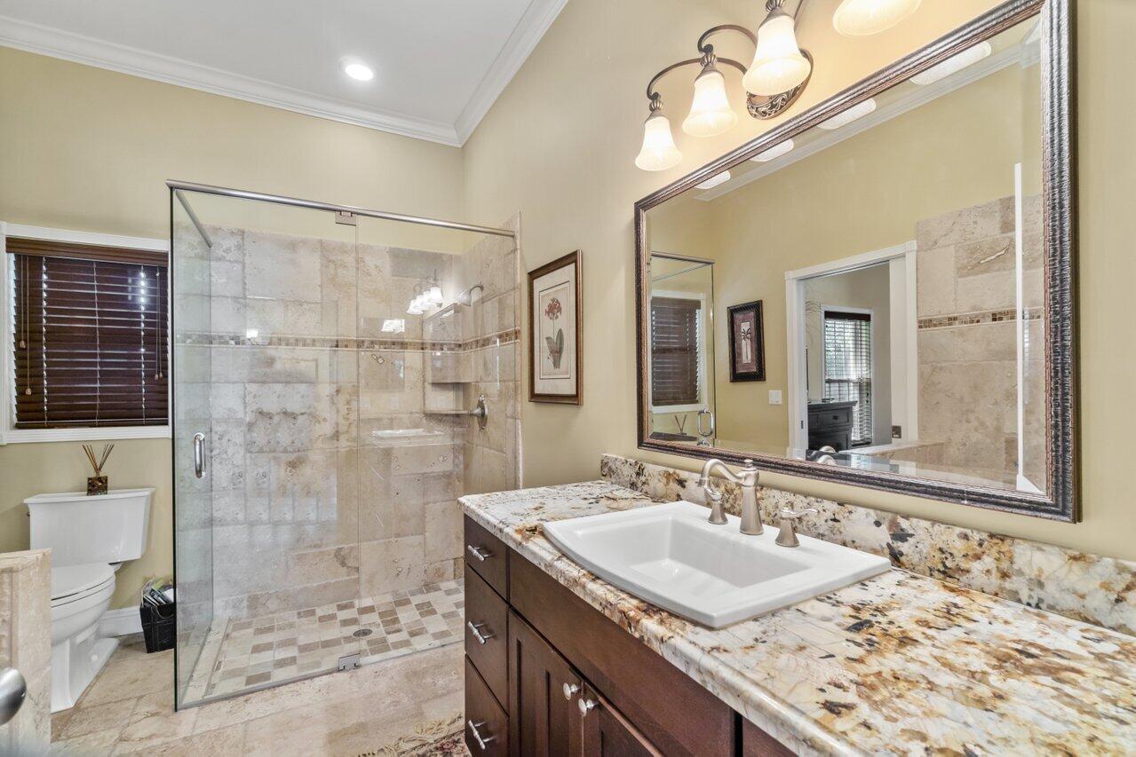 5861 Roebuck Road Jupiter, FL 33458 - Photo 37 of 74 a bathroom with a granite countertop sink mirror and shower