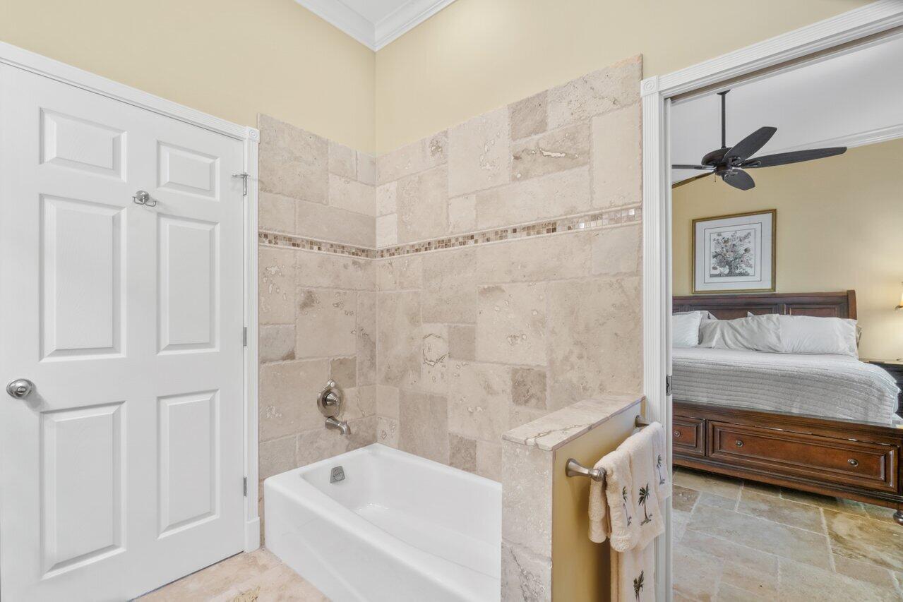 5861 Roebuck Road Jupiter, FL 33458 - Photo 38 of 74 a bathroom with a tub and a shower