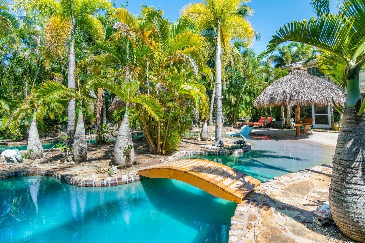 5861 Roebuck Road Jupiter, FL 33458 - Photo 49 of 74 a view of a swimming pool with a patio