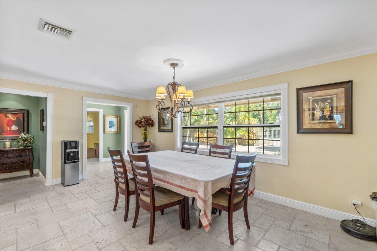 5861 Roebuck Road Jupiter, FL 33458 - Photo 5 of 74 a view of a dining room with furniture large window and chandelier
