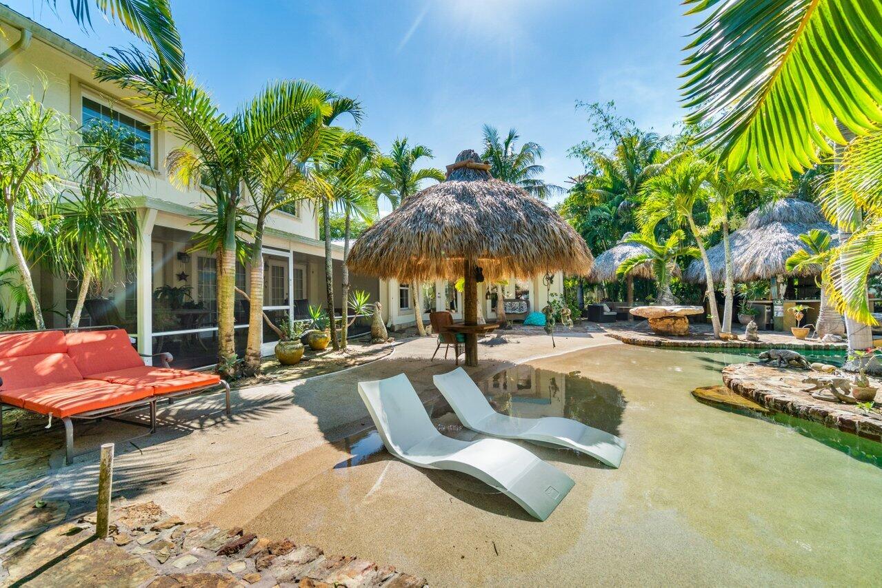 5861 Roebuck Road Jupiter, FL 33458 - Photo 52 of 74 a view of a swimming pool with lounge chair