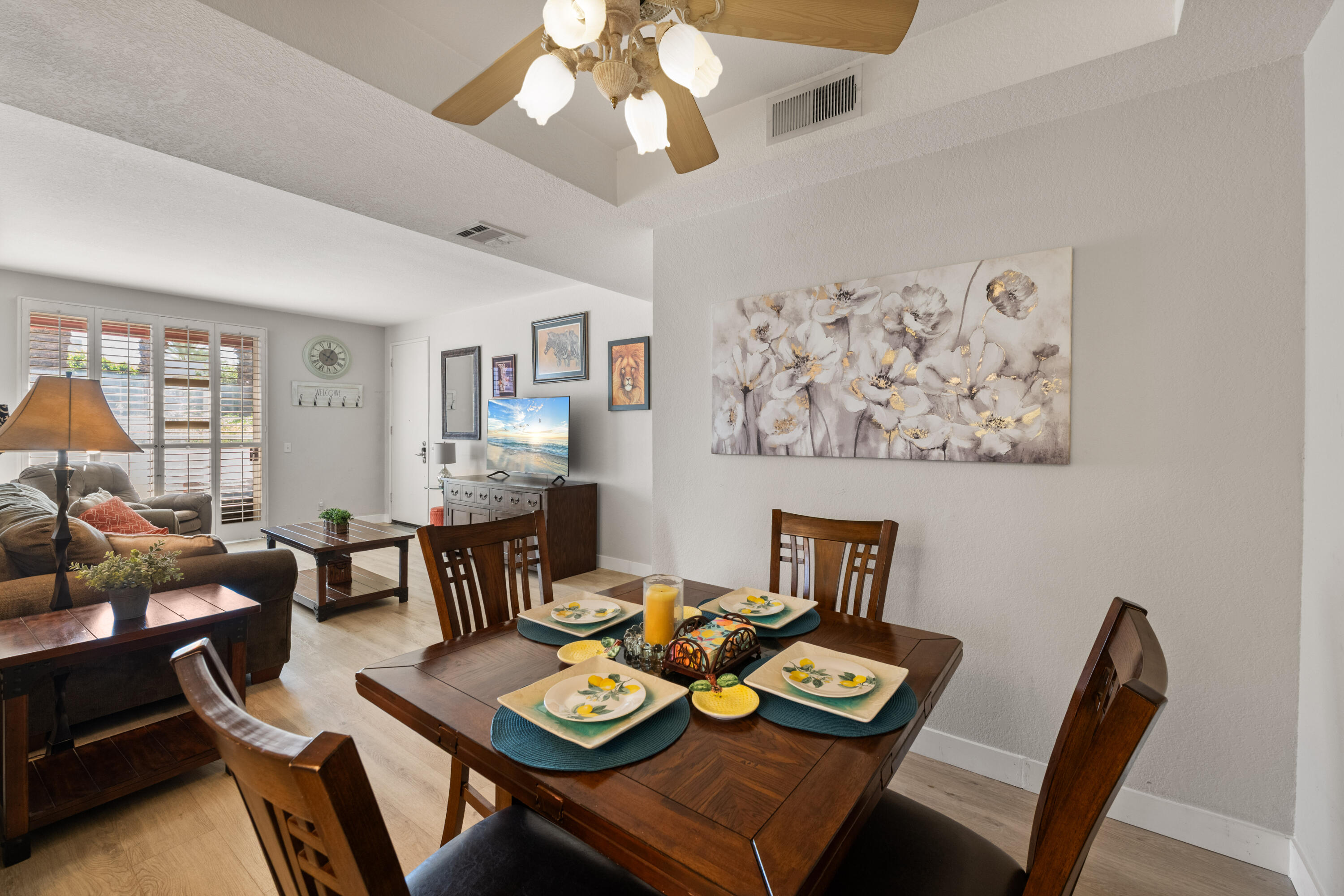 a view of a dining room with furniture a rug and wooden floor