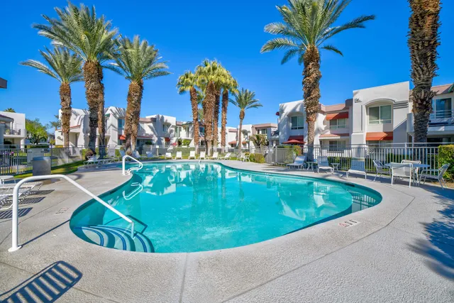 a view of a swimming pool with a table and chairs